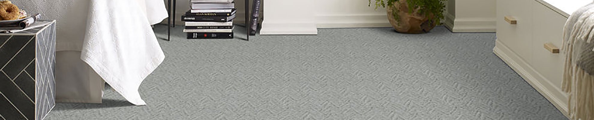 A modern bedroom with grey carpet