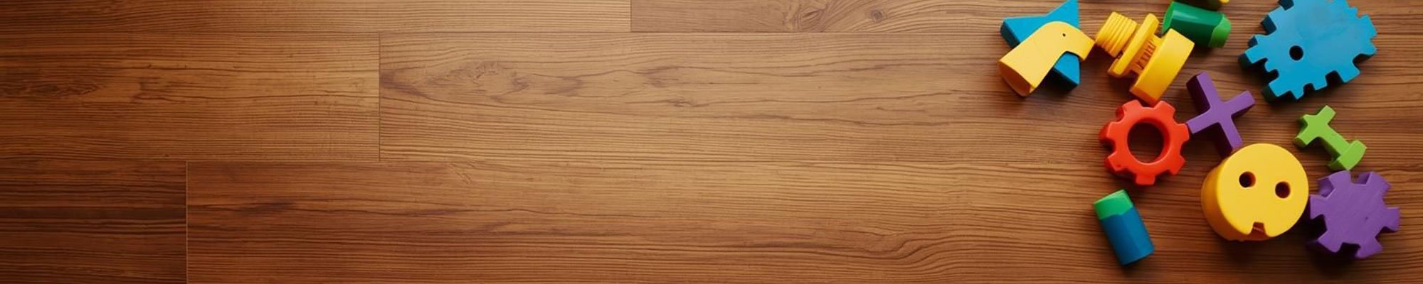 A top down image of children's block toys on hardwood floors